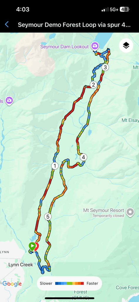 Cyclist walking bike up steep grade on Twin Bridges Trail