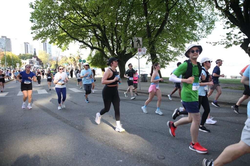 Runners on the BMO Vancouver Half Marathon course near English Bay